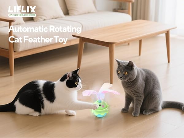 Multiple cats playing with glowing green ball toys on a wooden floor near furniture.