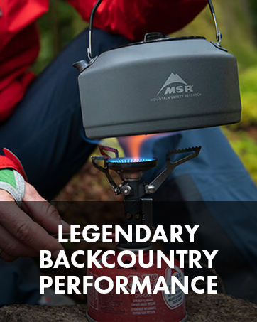 Person putting a kettle on a backpacking stove