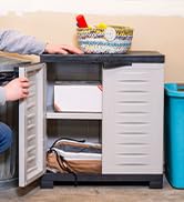 Plastic storage cabinet with 1 shelf and 2 doors in the garage with hammock inside and decor on top