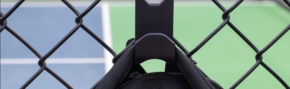 Chain link fence hook holding a sports bag on a pickleball court fence