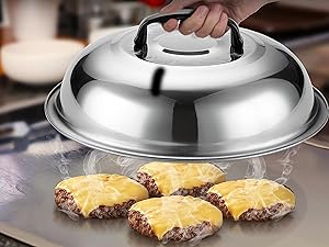 Stainless steel food dome covering four cheeseburger patties on a glass plate. The dome has a black handle on top for lifting.