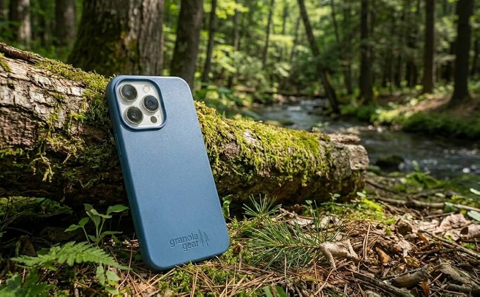 Blue biodegradable case leaned against a log in the woods in Michigan