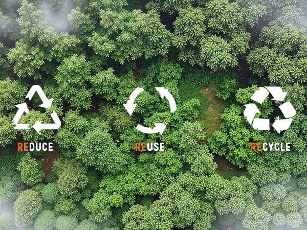 Aerial view of lush green forest with three recycling symbols overlaid, labeled 'Reduce', 'Reuse', and 'Recycle' in white and colored text.