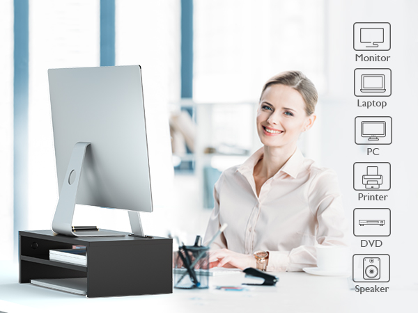 a woman sitting at a desk with a computer in front of her.