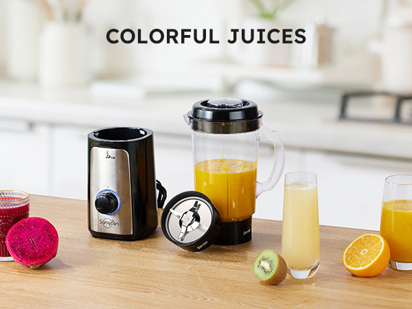 Blender with colorful fruit juices and fresh fruit on a kitchen counter.