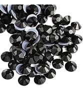 Collection of black faceted crystal or glass beads arranged in groups, showing their reflective surfaces and geometric cuts.
