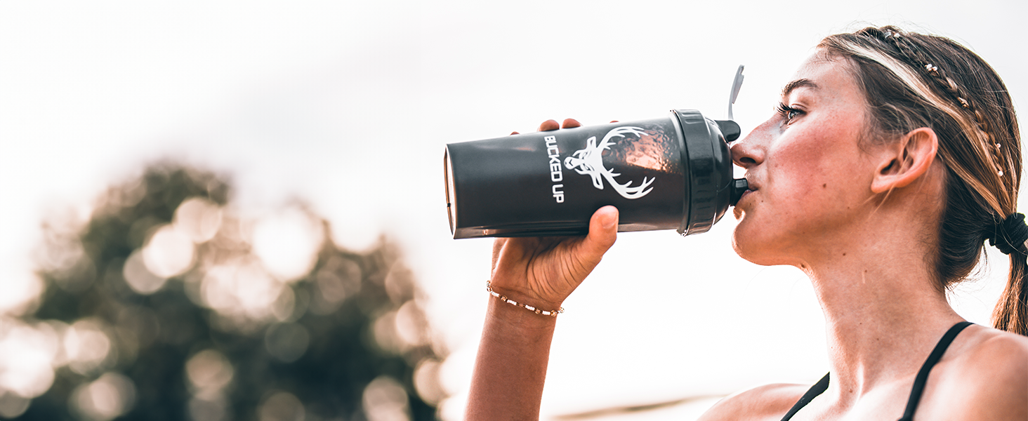 Woman drinking from Bucked Up Perfect Shaker bottle