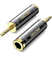 Text reads 'UGREEN'. Professional product photo of 3.5mm audio adapter with gold-plated connectors, featuring male to female conversion.