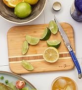 Totally Bamboo Barbados Bamboo Wood Cutting Board with sliced limes.