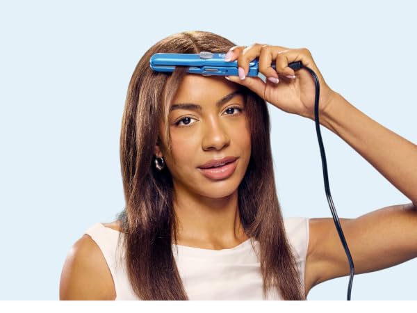 Woman straightening hair