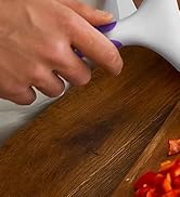 pizza roller dough tool rolling across dough to create small holes for baking