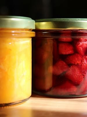 Fruit inside small glass jars with gold metal lids