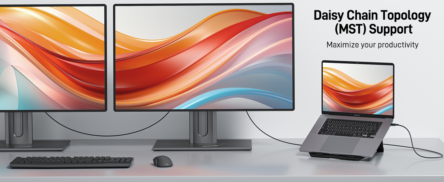 Multi-monitor setup with two large displays and a laptop connected via daisy chain topology. Keyboard and mouse visible. Text mentions 'Daisy Chain Topology (MST) Support' for maximizing productivity.