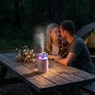 Mini diffuser with colorful light on a camping table – perfect for romantic outdoor evenings