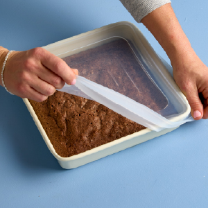 Silicone stretch lid covering an 8x8 glass baking dish