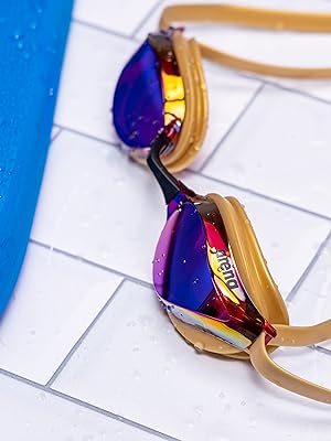 arena unisex adult swim goggles in copper on white tile next to pool for training racing competition