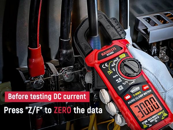 Red digital multimeter in use, measuring DC current. Text instructs to press 'Z/F' to zero the data before testing.