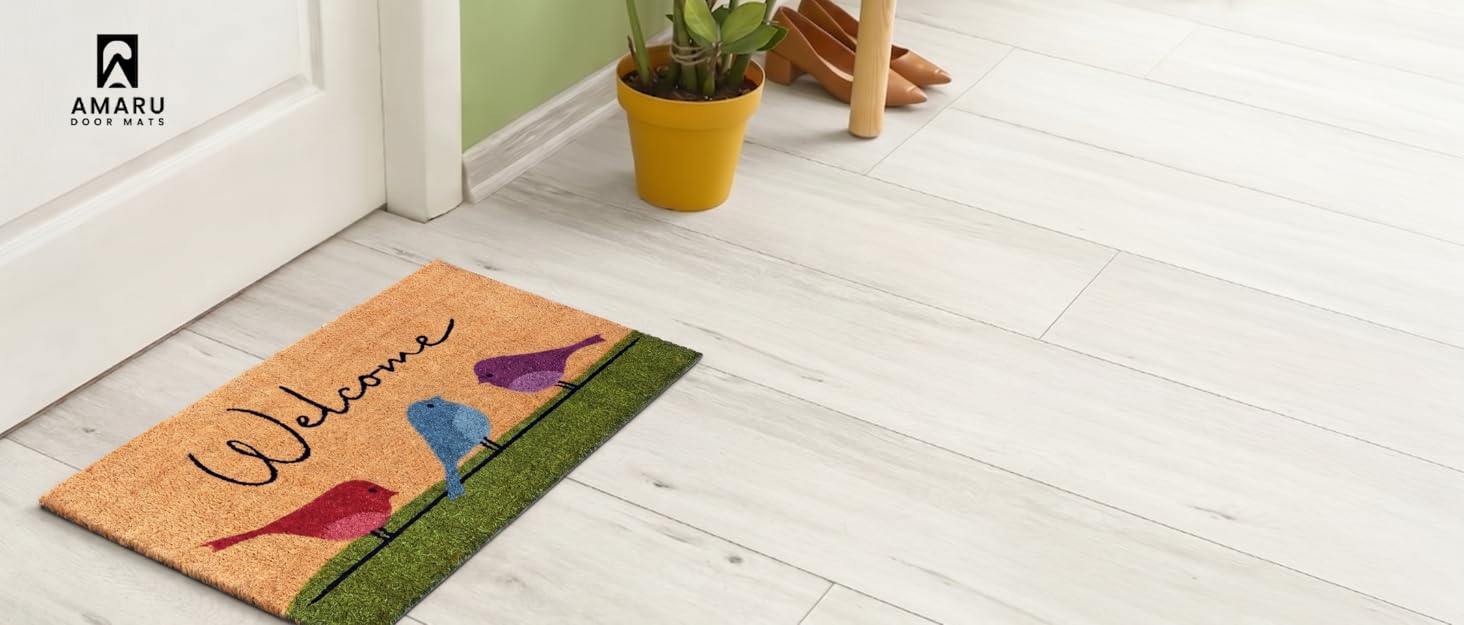 Indoor kitchen scene with doormat on white tile floor near orange juice glass. Ambly branded logo visible.