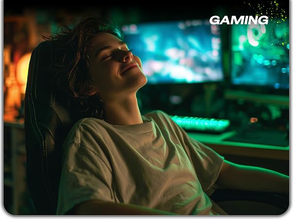 woman smiling at gaming desk using ergonomic mouse pad with wrist rest support