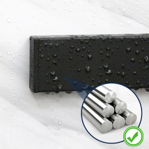 Black rectangular object with water droplets on surface. Inset circular image shows white cylindrical objects, possibly pills or capsules.