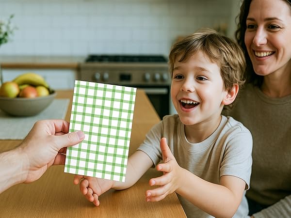 Kid celebrates birthday with friends and blank note cards and envelopes.