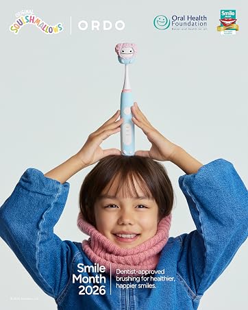 Text reads 'ORDO', 'Oral Health Foundation', 'Smile Month 2026'. Child holding pink toothbrush overhead wearing blue sweater. Dental hygiene promotional image with health organization logos.