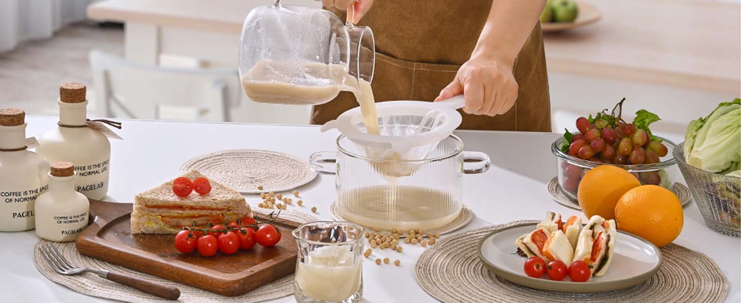 in the morning, woman brews soy milk and drinks it, sandwich and fruits for breakfast