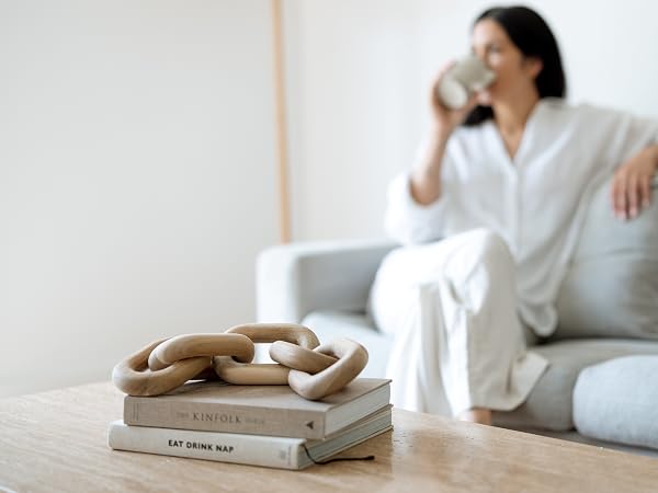 Peakoly acacia wood chain link layered over decor books on coffee table