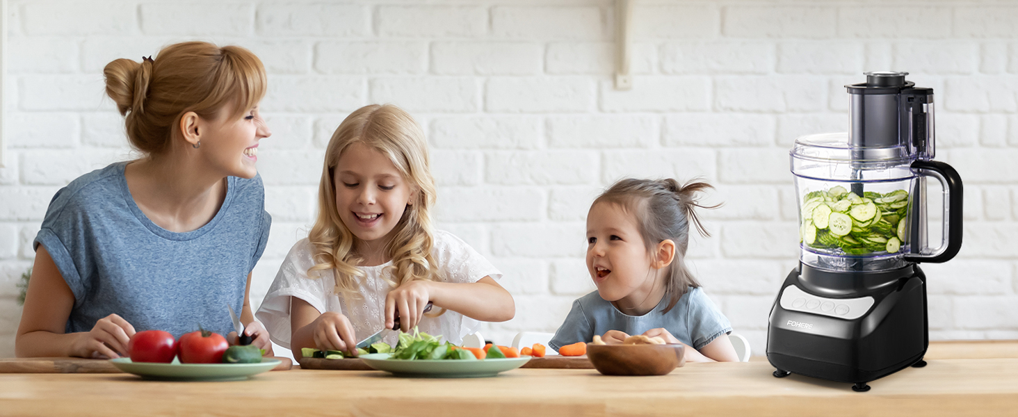 two little girls sitting at a table with a plate of vegetables.