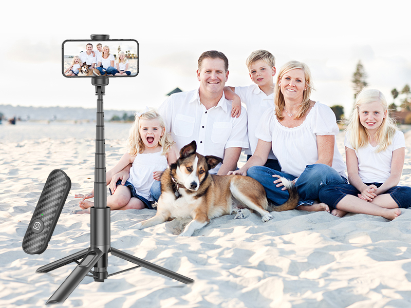 Extendable selfie stick and tripod stand with phone mount, featuring black grip texture and collapsible design.