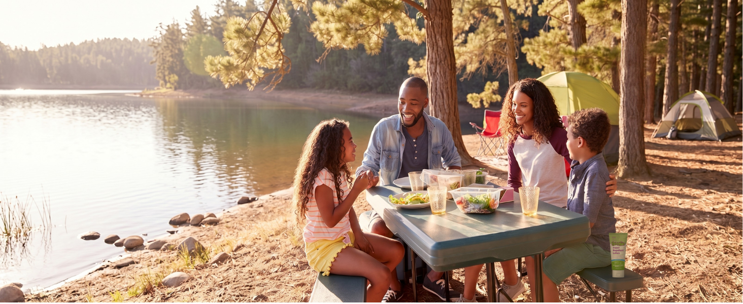 a family having lunch outside at their campsites