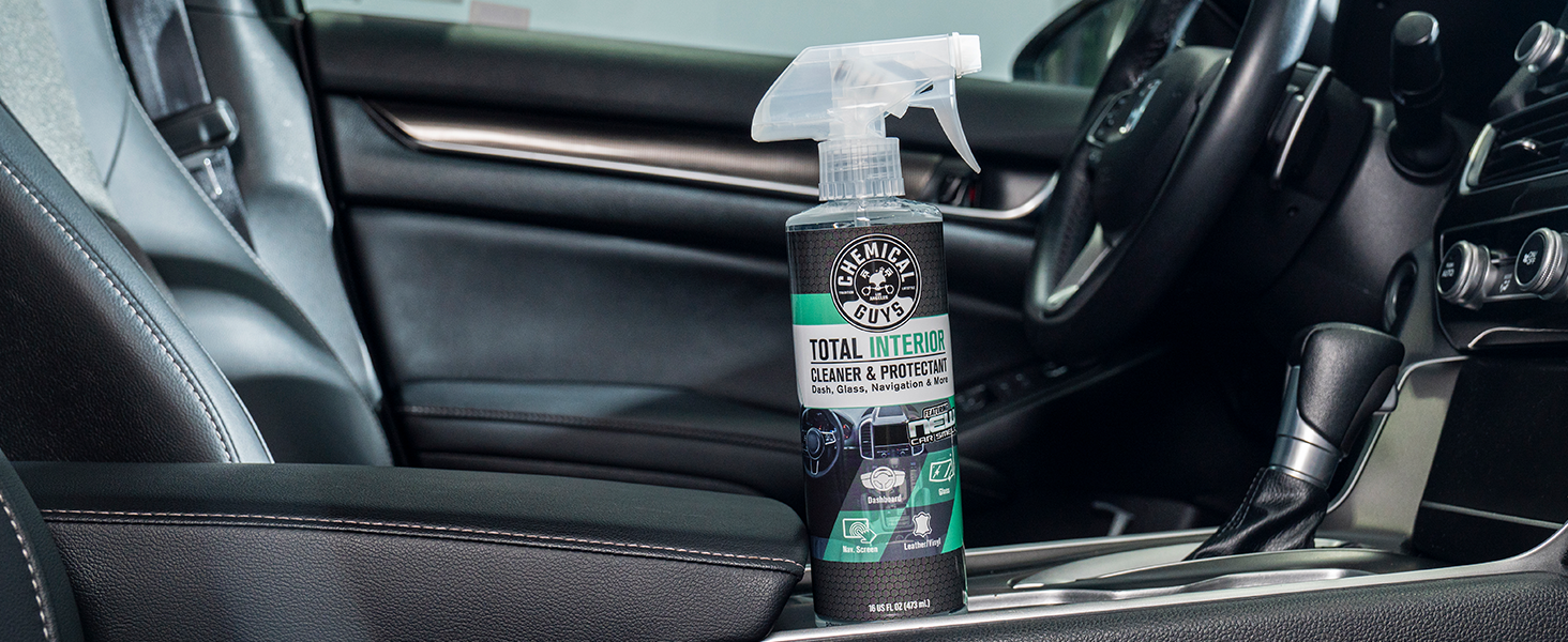 Detailer using Total Interior Cleaner on dashboard for streak-free clean