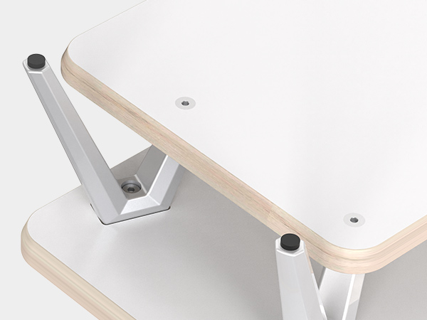 Close-up view of a metal bracket or mounting hardware, showing silver metal supports attached to beige-colored surfaces.