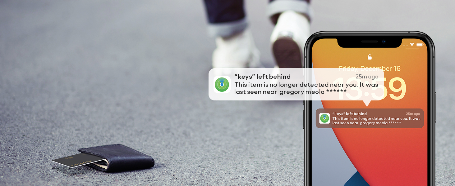 Smartphone displaying notification screens next to a dark wallet or card holder on asphalt surface.