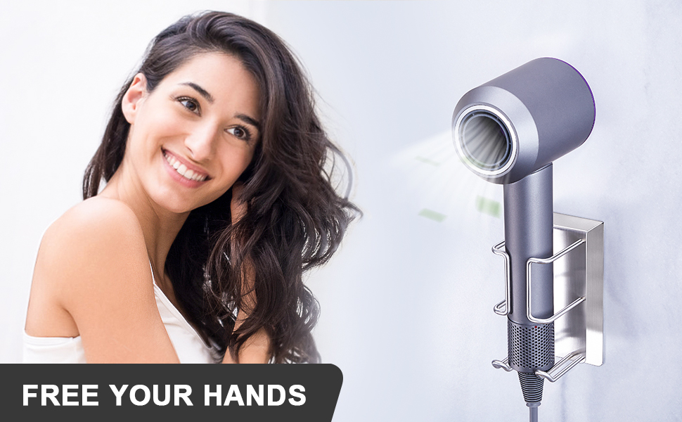 Wall-mounted hair dryer holder in metallic grey finish, with 'FREE YOUR HANDS' text visible at bottom.