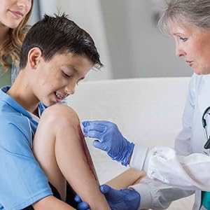 A doctor cleaning a child's wound