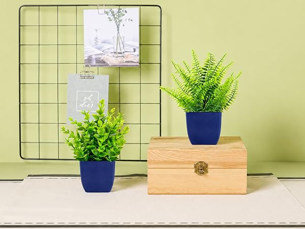 two artificial green plants blue pots tabletop decor