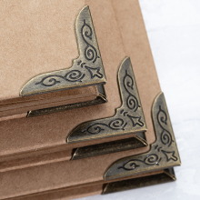 Metal Corner Protectors protects scrapbooks