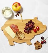 pig shaped cutting board serving charcuterie meat cheese fruit and crackers