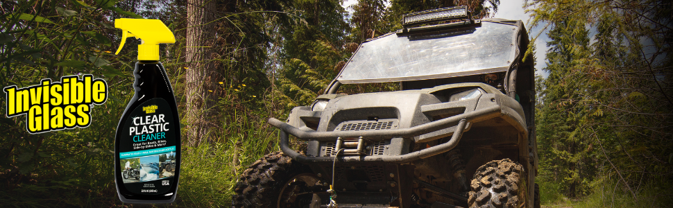 invisible glass clear plastic cleaner next to utv in the woods