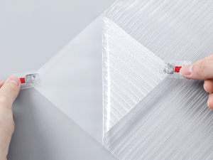 a person's hand is drawing a paper with a red pen.