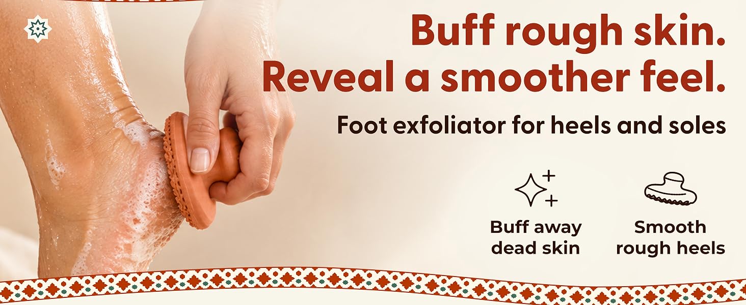 A hand uses a terracotta foot exfoliator on a wet, soapy heel