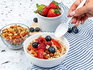 Spoon about to dip in a bowl of oatmeal.