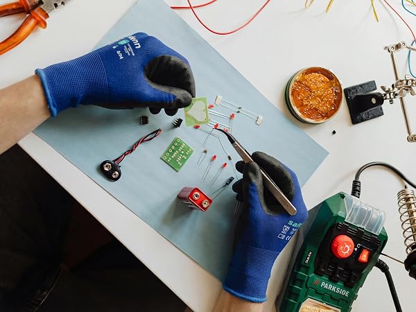 Blue precision work gloves for delicate electronics assembly and soldering tasks.