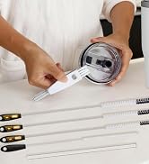Person arranging multiple cylindrical containers (white, purple, green, pink) and small black items on white surface with organized layout tools.