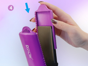 Purple hair styling tool with a wide flat iron plate and a rounded brush attachment. Hand demonstrates inserting the brush into the device.