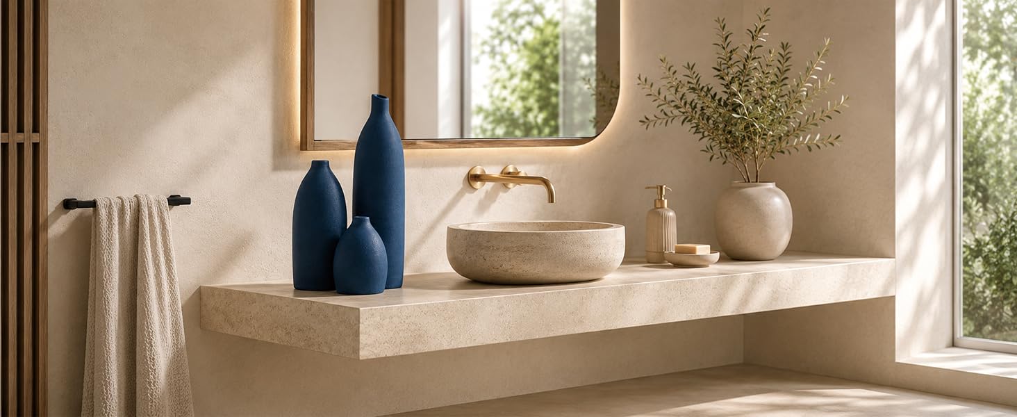 Coastal blue ceramic vase set on a laundry room countertop with natural wood cabinets.