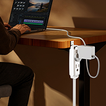 Maximm flat extension cord plug connected to a white laptop power adapter.