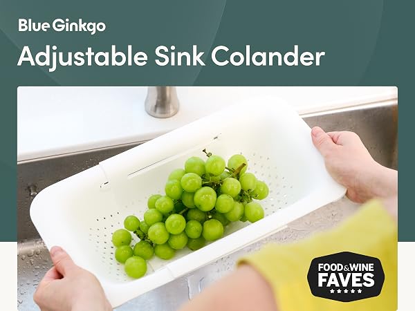 Sink colander basket held in hand with fresh produce, showing size and easy handling