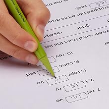 Green barrel pencil filling in test answers